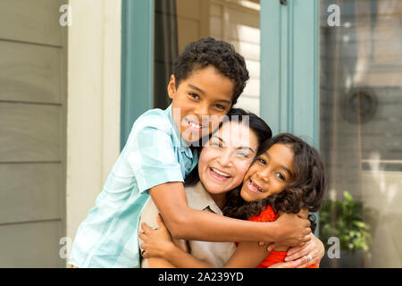 Happy Hispanic mother laughing and talking with her children. Stock Photo