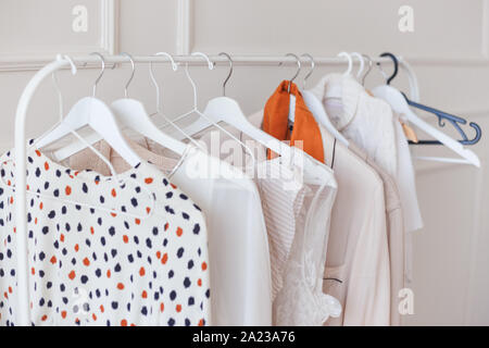 Clothes hang on a shelf in a designer clothes store Stock Photo