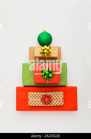 Christmas composition. Christmas gift boxes laid out in the shape of a Christmas tree on white background. Flat lay, top view, copy space. Stock Photo