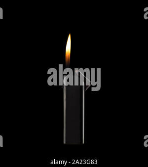Orange flame from a gas lighter. A lighter is isolated over a black background. Copy space. Stock Photo