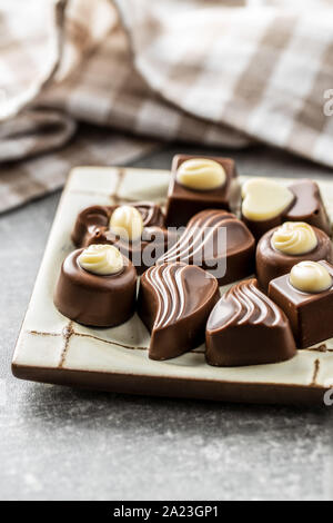 Various chocolate pralines on plate. Stock Photo