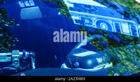 Police speed radar inside of police car. Patrol monitors traffic on a highway or on the roads of municipal district. Modern speed trap at a road. Poli Stock Photo