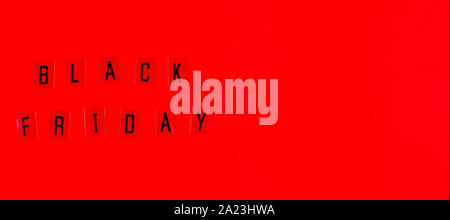 Black Friday sale tag on red background. Stock Photo