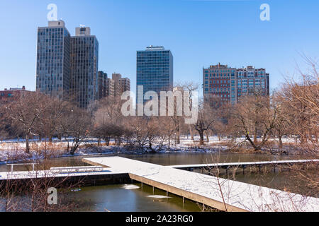 North Pond Walkway during Winter with Snow in Lincoln Park Chicago with Buildings Stock Photo