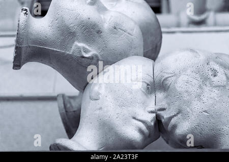 Styrofoam human head mannequins joined together Stock Photo
