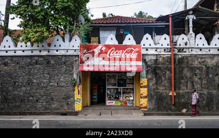 KANDY/ SRI LANKA, AUGUST 04, 2019: Little shops, small business in the streets of the small town with the blur of the motorcycle. Stock Photo