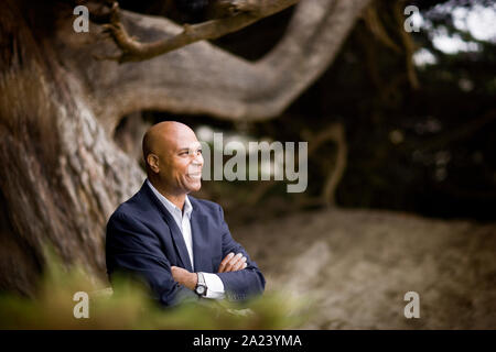 Side view of thinking man with crossed arms looking down. Full body ...