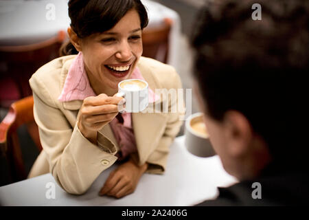 View of a couple conversing over a cup of coffee. Stock Photo