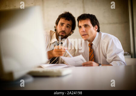Front view of two professionals engrossed in their work. Stock Photo
