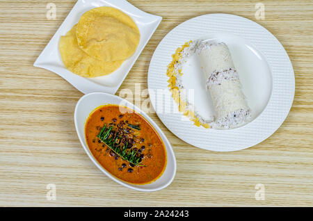 Traditional Kerala breakfast dish - Puttu with black chickpeas curry & pappad Stock Photo