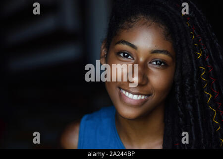 Interior close up portrait of young black woman with dreadlocks, Cali, Colombia