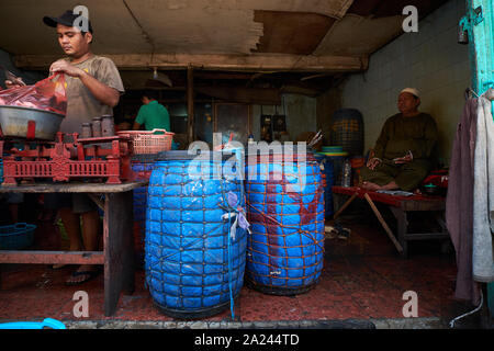 Fish and seafood sellers busy sorting their stock at the old, local, traditional market, Pasar Pabean. In the Arab Quarter section of Surabaya, Indone Stock Photo