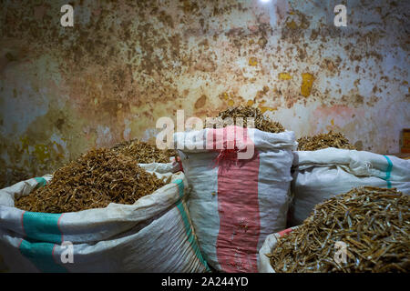 Sacks overflowing with small, dried fish for sale at the old, local, traditional market, Pasar Pabean. In the Arab Quarter section of Surabaya, Indone Stock Photo