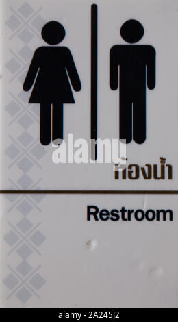restroom sign in English language and thai Stock Photo