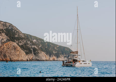 Sailing yaht in open sea on beautiful sunset sky background Stock Photo