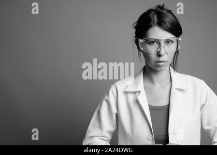 Scientist doctor wearing protective glasses shot in black and white Stock Photo