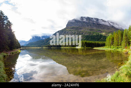 Morning view of the Fishercap Lake with reflection at Glacier National Park Stock Photo