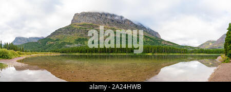 Morning view of the Fishercap Lake with reflection at Glacier National Park Stock Photo