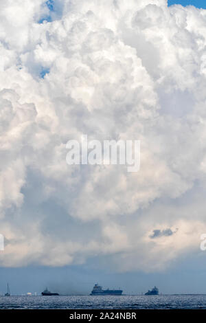 Massive cloud formations over ocean with cargoships on the background, Galveston, Texas, USA Stock Photo