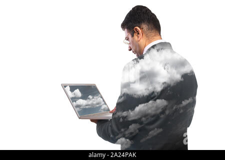 Rear view of  businessman working on laptop computer with shades of clouds Stock Photo