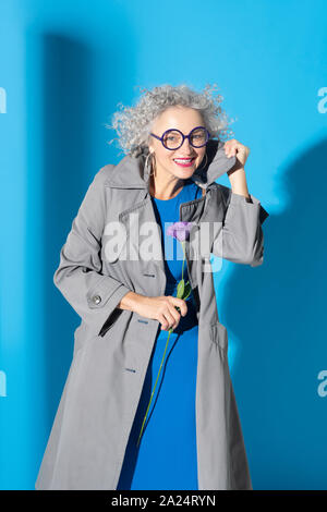 Curly woman fashionable wearing glasses smiling broadly Stock Photo