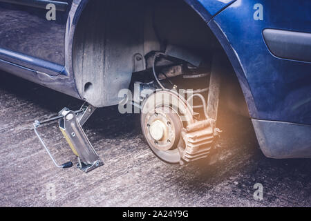 Car tire change concept - closeup of a car wheel after removing flat tire Stock Photo