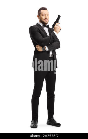 Full length portrait of a man in a suit holding a gun isolated on white background Stock Photo