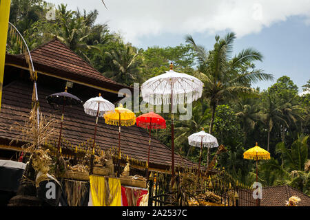 Group of beautiful Balinese flags and umbrellas at celebration ceremony in Hindu temple. Traditional design, arts festivals, culture of Bali island Stock Photo