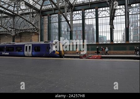 Passengers boarding Scotrail Class 380 Desiro electric trains at Glasgow Central Station Stock Photo