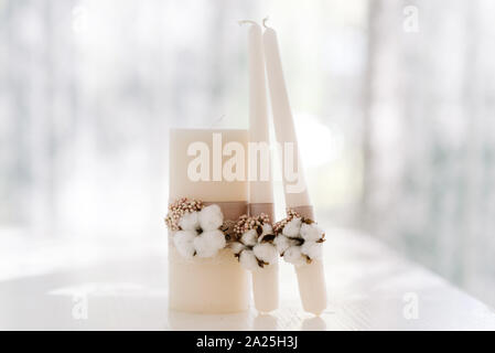 Stylish wedding accessories are white in rustic style. Set of candles Stock Photo