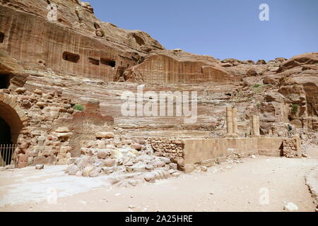 first century AD Nabatean theatre in Petra, Jordan. Substantial part of the theatre was carved out of solid rock, while the scaena and exterior wall were constructed. The theatre's auditorium consists of three horizontal sections of seats separated by passageways and seven stairways to ascend. The theatre could accommodate a number of approximately 8500 people. The theatre was built in the cultural and political apex of the Nabatean kingdom under Aretas IV (9 BC-40 AD), In 1812, the city of Petra and Al-Khazneh was rediscovered by Swiss explorer Johann Ludwig Burckhardt Stock Photo