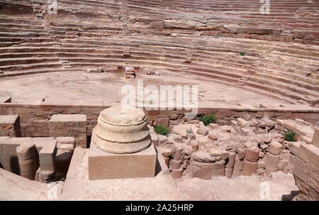 first century AD Nabatean theatre in Petra, Jordan. Substantial part of the theatre was carved out of solid rock, while the scaena and exterior wall were constructed. The theatre's auditorium consists of three horizontal sections of seats separated by passageways and seven stairways to ascend. The theatre could accommodate a number of approximately 8500 people. The theatre was built in the cultural and political apex of the Nabatean kingdom under Aretas IV (9 BC-40 AD), In 1812, the city of Petra and Al-Khazneh was rediscovered by Swiss explorer Johann Ludwig Burckhardt Stock Photo