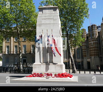 The Cenotaph war memorial on Whitehall in London, England. Its origin is in a temporary structure erected for a peace parade following the end of the First World War, and after an outpouring of national sentiment it was replaced in 1920 by a permanent structure and designated the United Kingdom's official national war memorial. Designed by Edwin Lutyens, the permanent structure was built from Portland stone between 1919 and 1920 Stock Photo