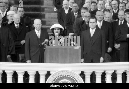 Photograph shows singer Marian Anderson performing at the Eisenhower Inauguration, as President Eisenhower and Vice President Richard Nixon stand behind her. 1957 Stock Photo