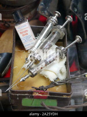 A collection of medical instruments from a concentration camp including syringes and a bottle of Merbromin. Stock Photo