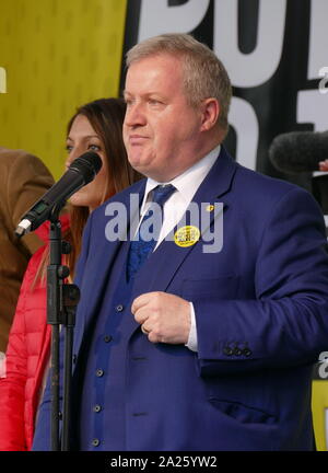 Ian Blackford, Scottish National Party Member of Parliament for Ross, Skye and Lochaber, leader of the SNP Westminster Group, addresses the 'People's Vote' march in Parliament Square, London. The People's Vote march took place in London on 23 March 2019 as part of a series of demonstrations to protest against Brexit, call for a new referendum, and ask the British Government to revoke Article 50. It brought to the capital hundreds of thousands of protestors, or over a million people according to the organizers. Stock Photo