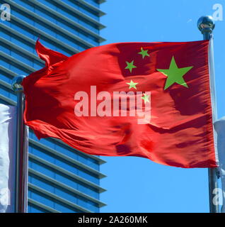 The flag of China, features one large star, with four smaller stars. The red represents the communist revolution; the five stars and their relationship represent the unity of the Chinese people under the leadership of the Communist Party of China (CPC). The first flag was hoisted by the People's Liberation Army (PLA) on a pole overlooking Beijing's Tiananmen Square on October 1, 1949, at a ceremony announcing the establishment of the People's Republic of China. Stock Photo