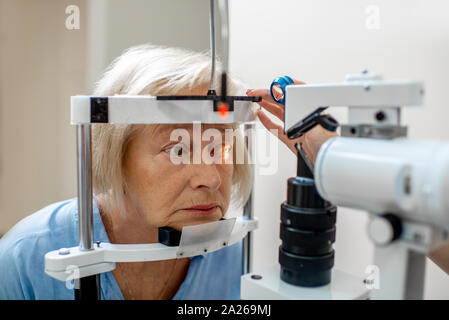 Senior woman during a medical eye examination with microscope in the ophthalmologic office Stock Photo