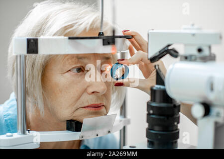 Senior woman during a medical eye examination with microscope in the ophthalmologic office, close-up Stock Photo