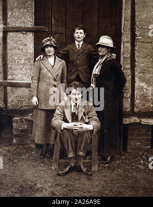 photograph taken at the Hertfordshire home of the Earl of Strathmore of Lady Elizabeth Bowes Lyon, (later Queen Elizabeth the Queen Mother) with Prince Paul of Yugoslavia, Lady Elizabeth's mother, and (seated) The Hon David Bowes Lyon, Lady Elizabeth's youngest brother 1920 Stock Photo