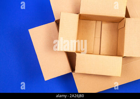 Empty open cardboard boxes on blue background Stock Photo