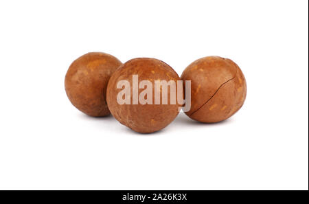 Close up group of three macadamia nuts isolated on white background, low angle side view Stock Photo