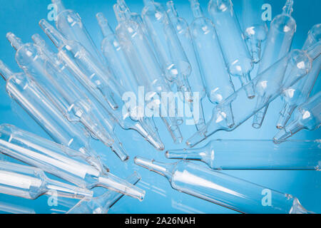 ransparent medical vials scattered on a transparent surface Stock Photo