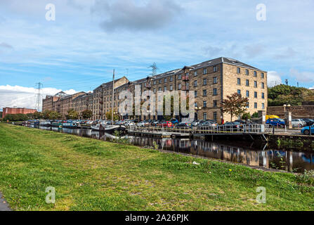 Old warehouses converted to flats at Speirs Wharf at the Glasgow branch of the Forth and Clyde Canal in Glasgow Scotland UK Stock Photo