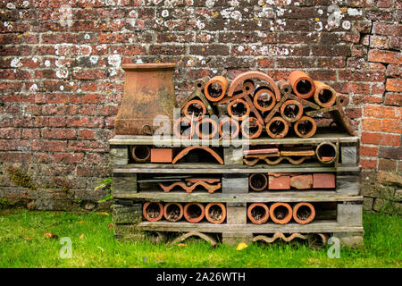 A large bee and insect hotel made from terracotta pots and wood palettes Stock Photo
