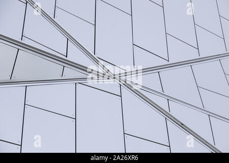 Close-up of junction of metal lines on white tiled wall of building Stock Photo