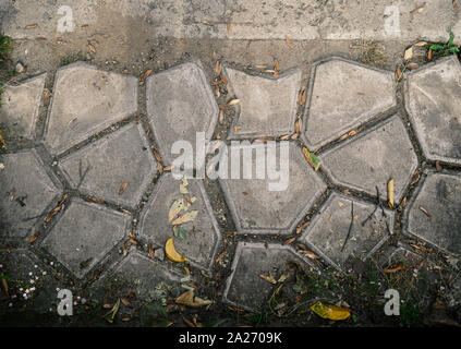 Old and cracked tile road. Selective focus. Stock Photo