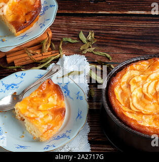 Homemade European-style apple pie. Accompanied by fresh apples and wooden background. Stock Photo
