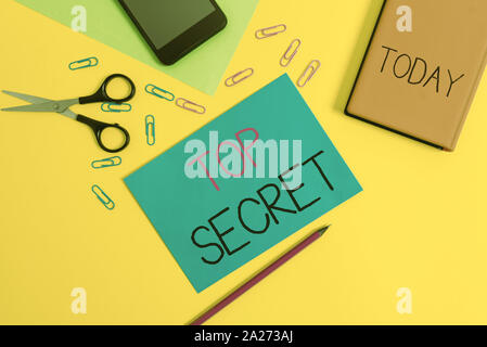 Handwriting text writing Top Secret. Conceptual photo telling someone important data or information that he cant tell Paper sheets pencil clips smartp Stock Photo