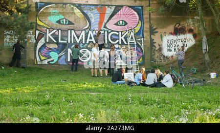 Activists people paints and repainting symbol Extinction Rebellion on legal wall for graffiti, action demonstration against climate change, people Stock Photo